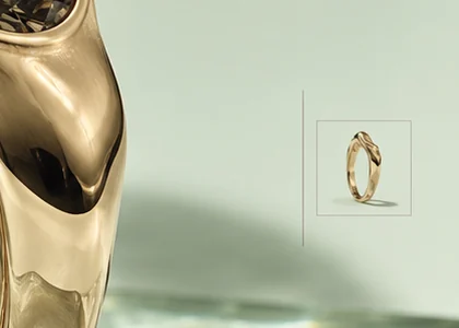 A small framed thumbnail of a slim twisted gold band at the edge of the page, beside the main ring's polished side