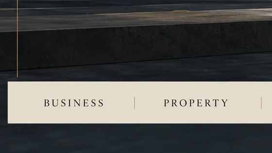 Close-up of a linen bar reading BUSINESS and PROPERTY in spaced serif capitals, below a dark stone step.