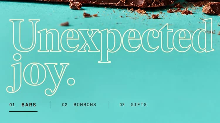 Unexpected joy. in a hollow cream outline serif on turquoise, above tabs 01 BARS, 02 BONBONS and 03 GIFTS.