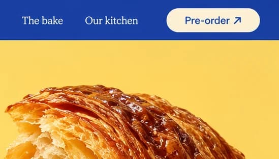Cobalt nav bar reading The bake and Our kitchen beside a cream Pre-order button, the croissant shell below.