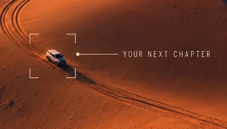 Close-up of a white 4x4 on a dune ridge framed by viewfinder brackets, labelled Your next chapter