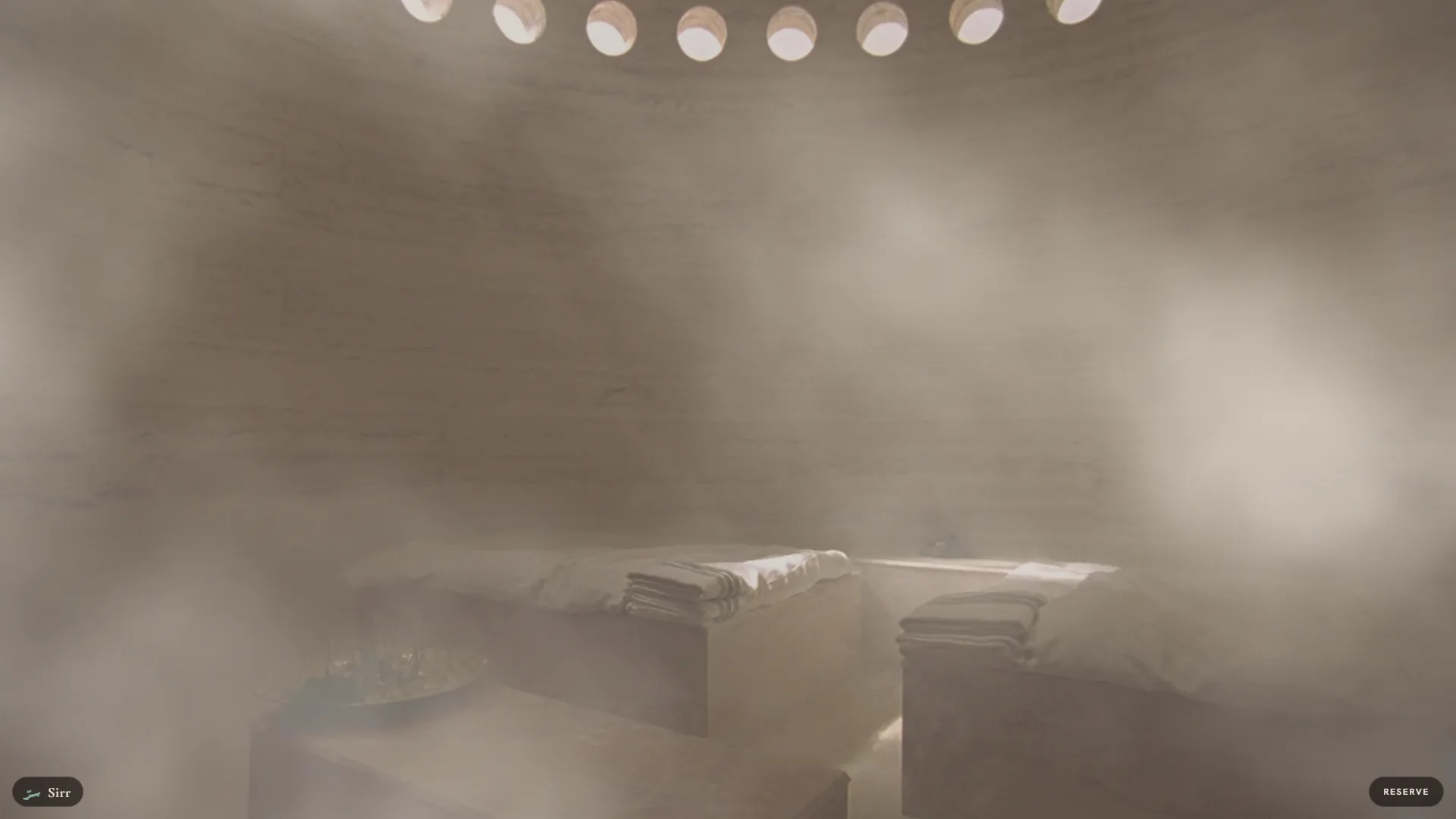 Sirr Hammam spa website: the domed cooling room appearing as white steam lifts, mid-scroll